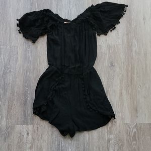 Black romper with pompom trim